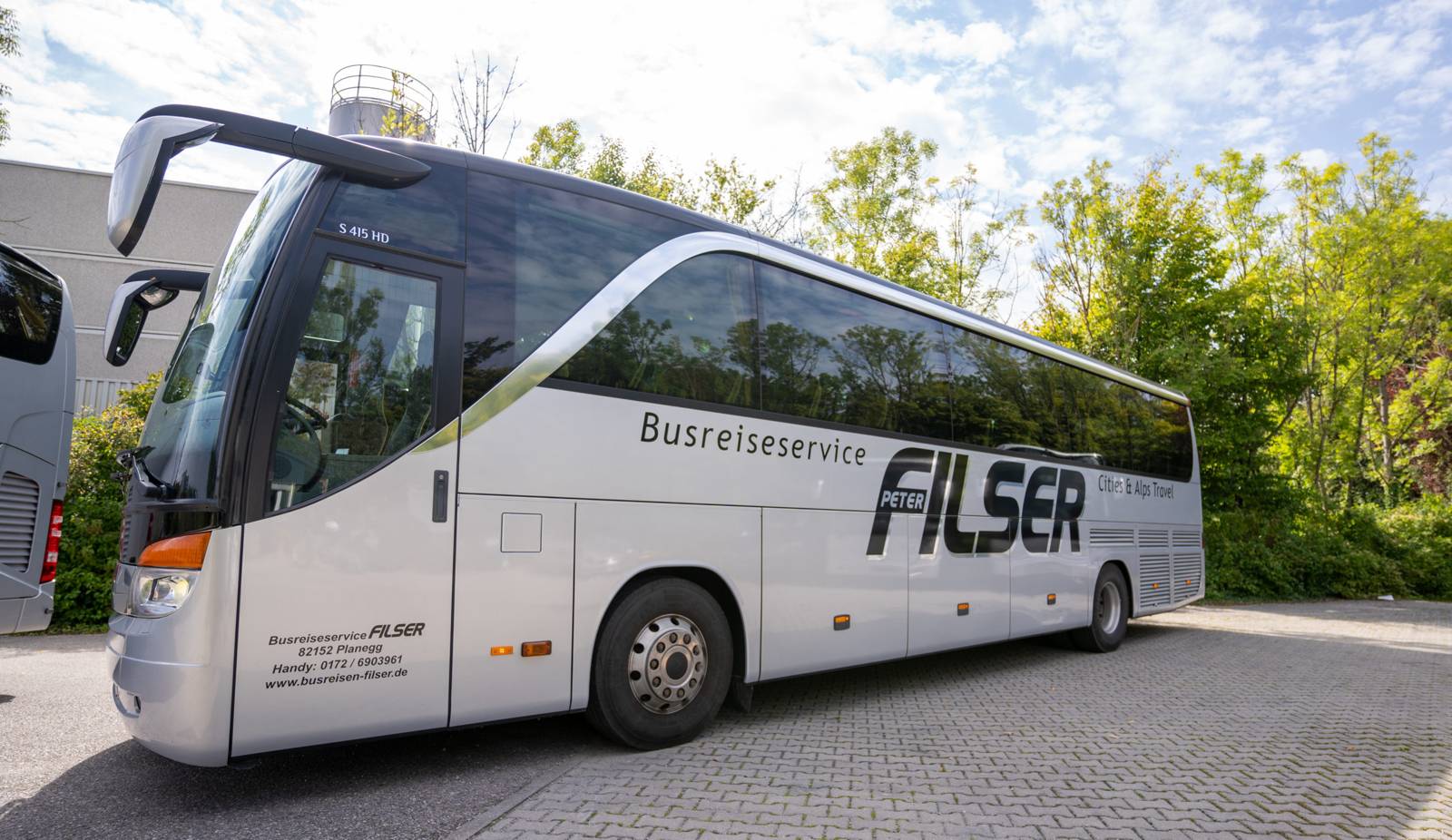 Silver touring coach with Filser lettering