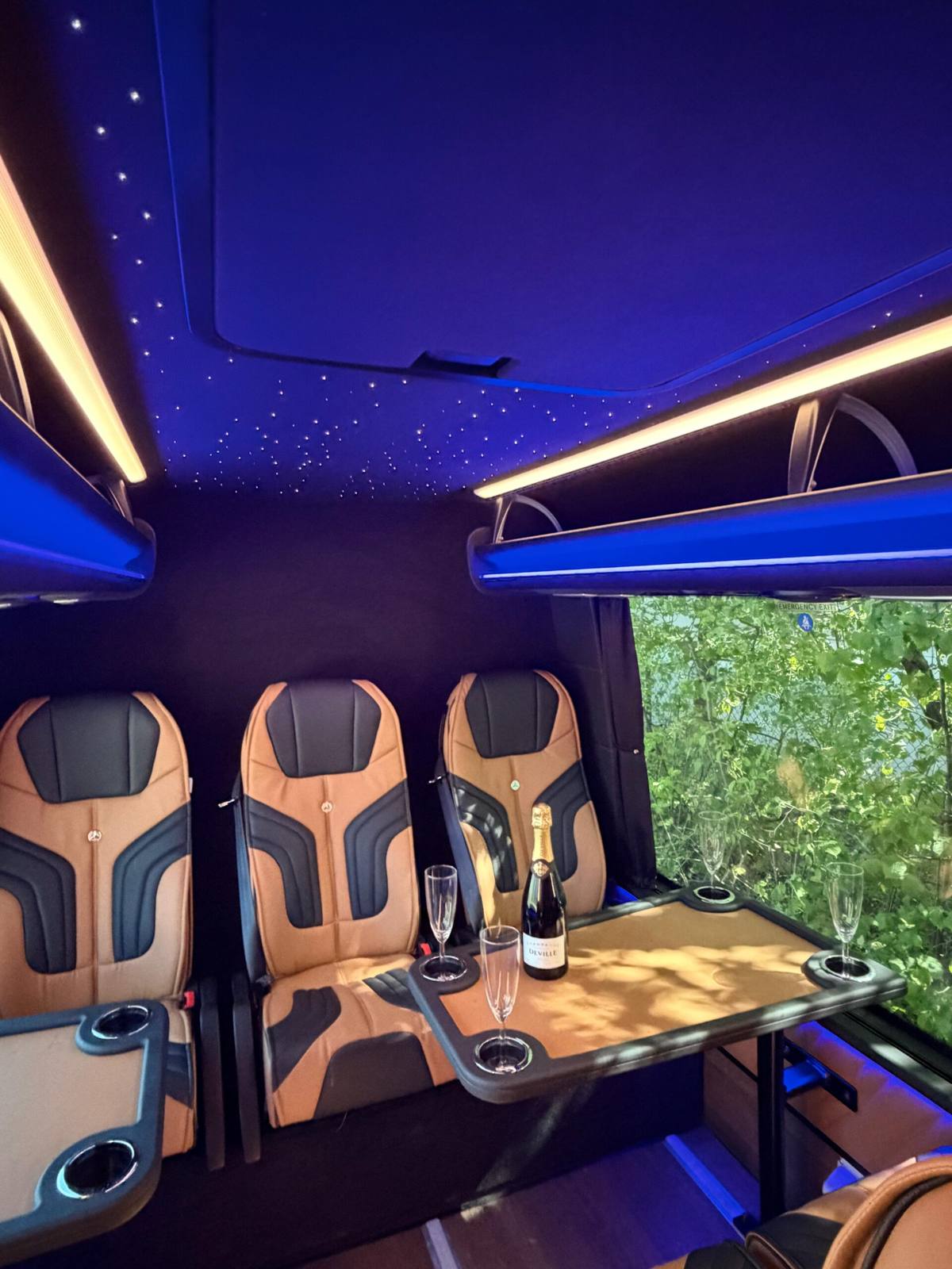 Seating area with conference table and sparkling wine in the VIP Sprinter